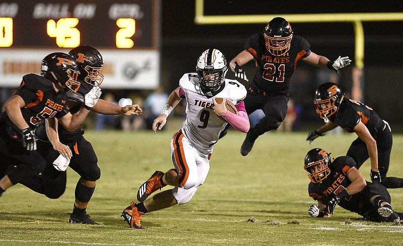 Staff photo by Robin Rudd / Meigs County's Jackson Fritts bursts through South Pittsburg's defense during a regular-season matchup at South Pittsburg on Oct. 11. South Pittsburg won 27-16 and is 11-0 headed into the quarterfinal round of the TSSAA Class 1A playoffs this week. Class 2A's Meigs County hasn't lost since then and is also in the state quarterfinals