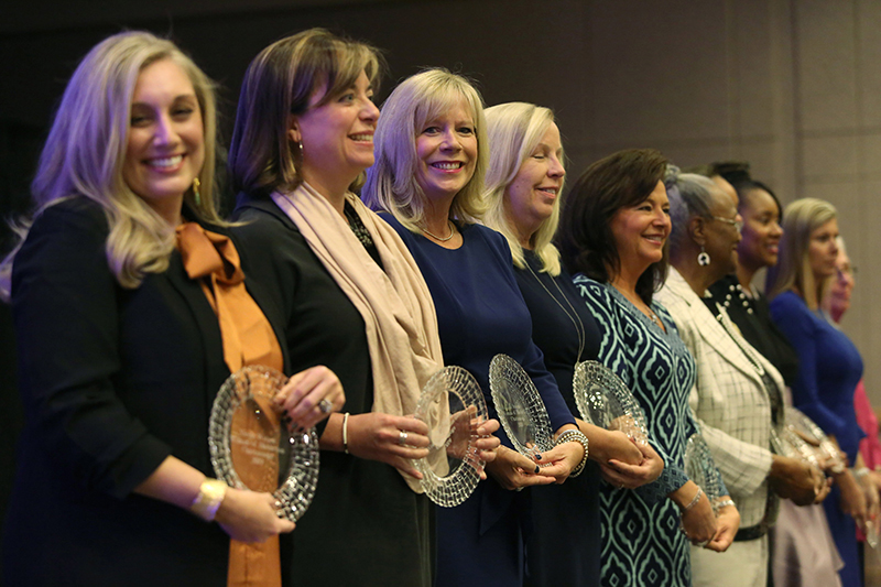Staff photo by Erin O. Smith / The 2019 Women of Distinction stand after being recognized during the Women of Distinction program at the Chattanooga Convention Center.