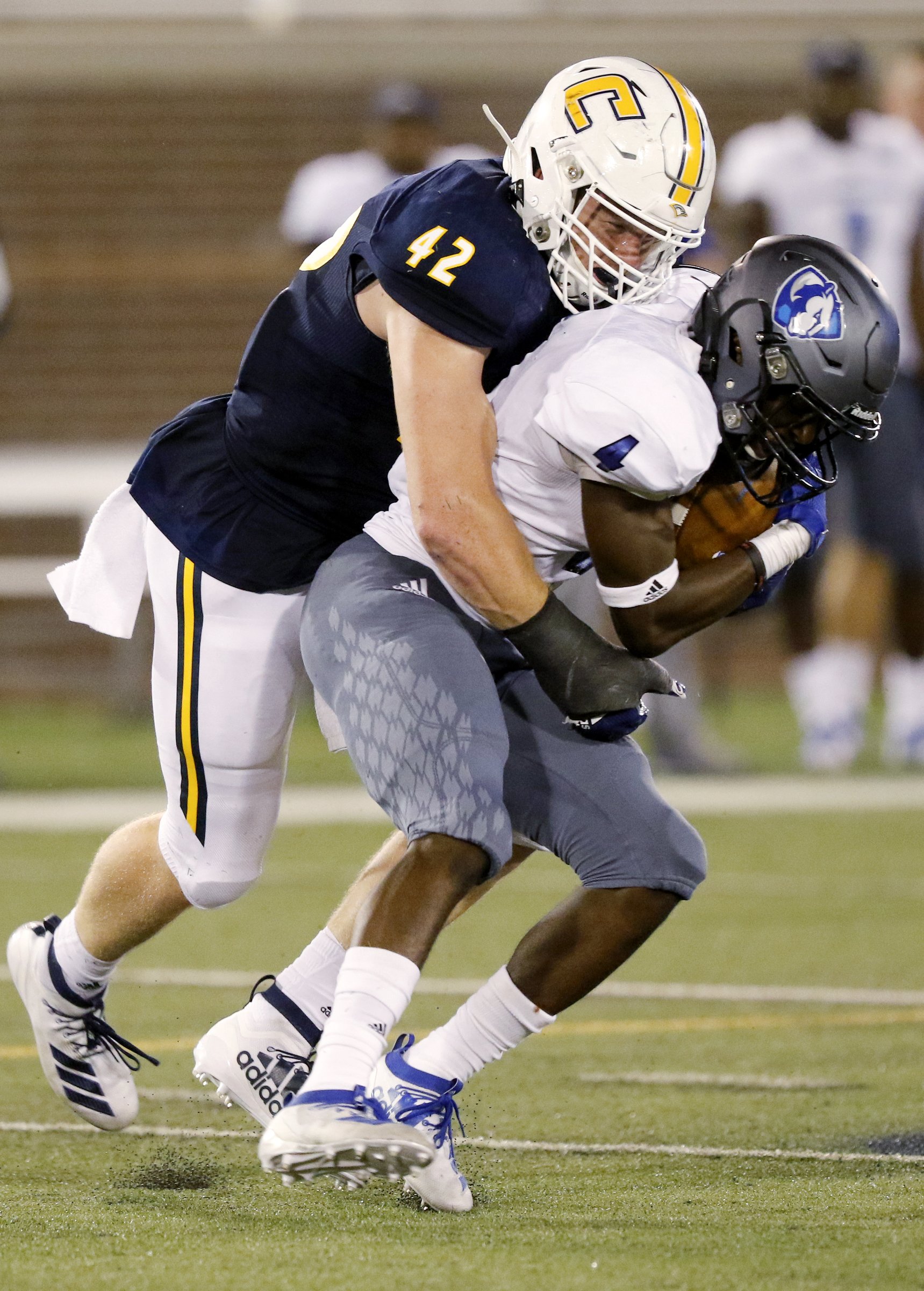 Staff photo by C.B. Schmelter / UTC linebacker Marshall Cooper tackles Eastern Illinois running back Jaelin Hayes-Benefield during the season opener Aug. 29 at Finley Stadium.