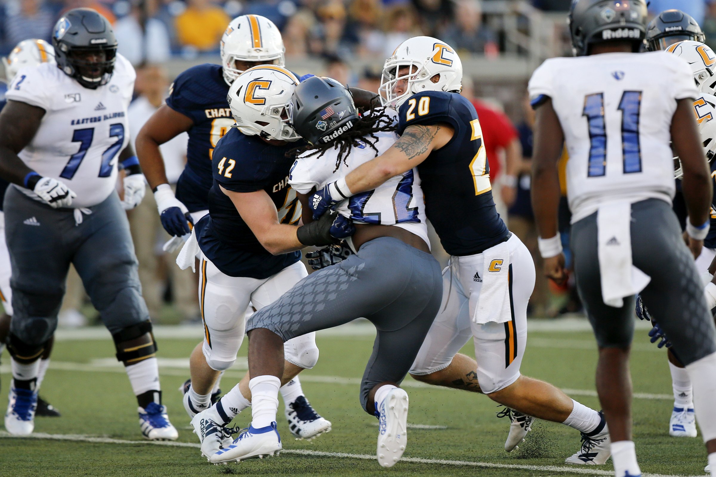 Staff photo by C.B. Schmelter / UTC linebackers Marshall Cooper (42) and Kayne Roberts (20) tackle Eastern Illinois running back Courtney Rowell during the season opener Aug. 29 at Finley Stadium. Cooper had 10 total tackles that day, and he has reached double figures in tackles in a game three times since then., with 10 at Jacksonville State, 12 at Wofford and 13 against The Citadel.