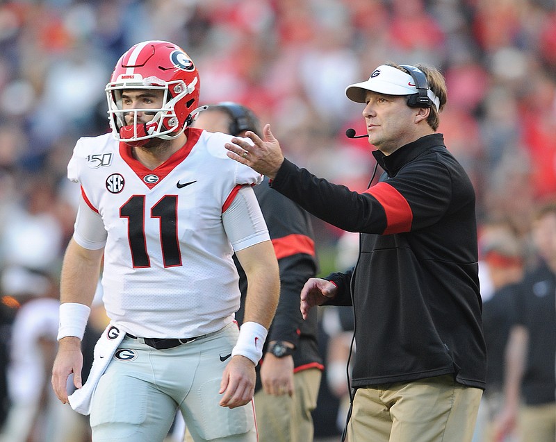 Georgia photo by Philip Williams / Georgia quarterback Jake Fromm and Bulldogs coach Kirby Smart visit on the sideline during last weekend's 21-14 win at Auburn.