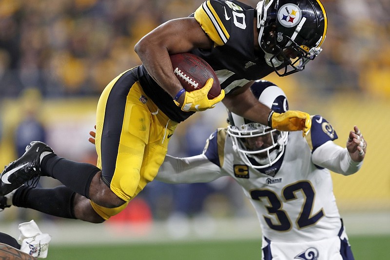 FILE - In this Nov. 10, 2019, file photo, Los Angeles Rams free safety Eric Weddle (32) tackles Pittsburgh Steelers running back Tony Brooks-James during the second half of an NFL football game in Pittsburgh. (AP Photo/Keith Srakocic, File)