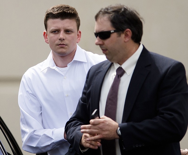 FILE - In this March 24, 2016, file photo, Montgomery Police Officer Aaron Smith, left, arrives for a hearing at the Montgomery County Courthouse in Montgomery, Ala. Lawyers gave opening statements Tuesday, Nov. 19, 2019, in the murder trial of Smith, an Alabama police officer charged with killing an unarmed man. Montgomery police Officer Aaron Cody Smith is charged in the 2016 shooting death of 58-year-old Gregory Gunn. (Albert Cesare/Montgomery Advertiser via AP, FIle)


