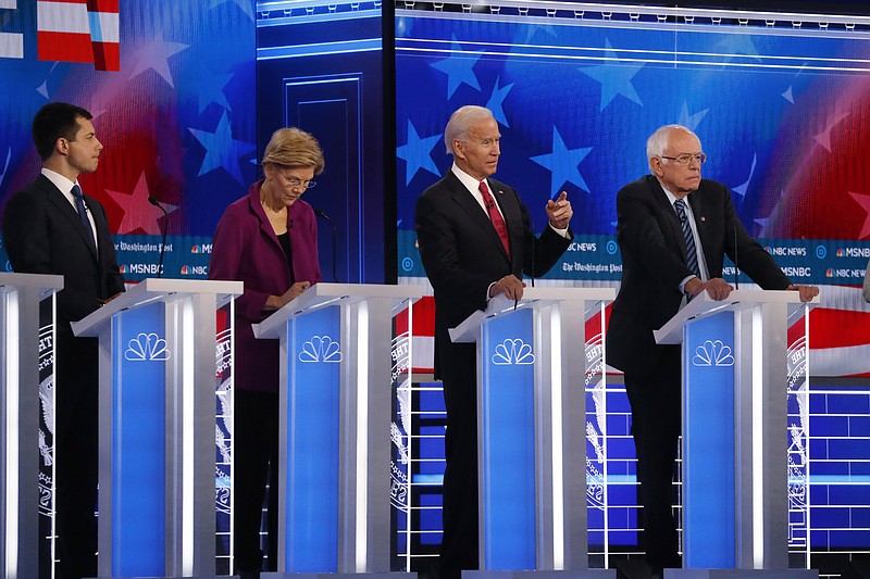 Democratic presidential candidate former Vice President Joe Biden, second from right, speaks as candidates Sen. Bernie Sanders, I-Vt.,, right, and South Bend, Ind., Mayor Pete Buttigieg, left, and Sen. Elizabeth Warren, D-Mass., second from left, watch during a Democratic presidential primary debate, Wednesday, Nov. 20, 2019, in Atlanta. (AP Photo/John Bazemore)