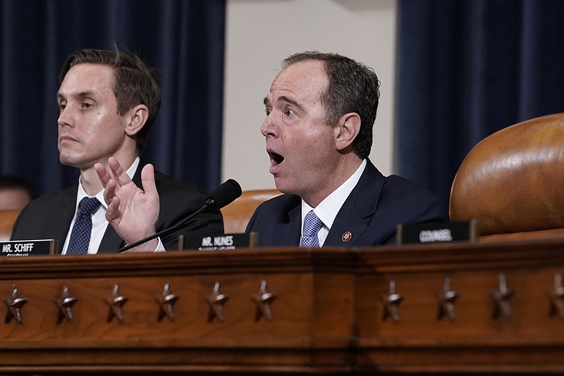 House Intelligence Committee Chairman Adam Schiff, D-Calif., with committee staffer Daniel Noble at left, makes impassioned remarks at the conclusion of a week of public impeachment hearings on Capitol Hill in Washington, Thursday, Nov. 21, 2019, on President Donald Trump's efforts to tie U.S. aid for Ukraine to investigations of his political opponents. Former White House national security aide Fiona Hill, and David Holmes, a U.S. diplomat in Ukraine, were the final witnesses today. (AP Photo/J. Scott Applewhite)