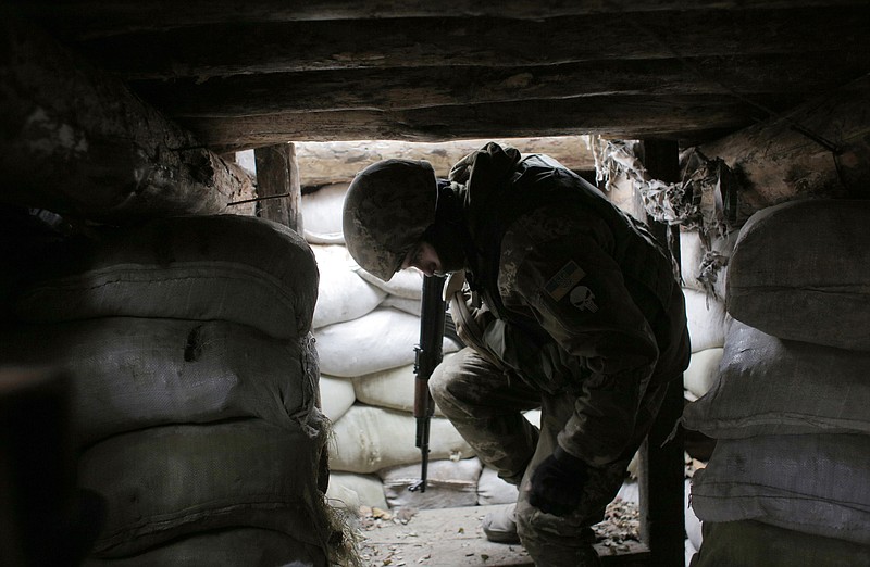 In this photo taken on Monday, Nov. 18, 2019, a Ukrainian soldier in a trench in the front line near the town of Avdiivka in the Donetsk region, Ukraine. U.S.-made X-ray equipment, helmets and missiles make a difference for Ukrainian troops fighting Kremlin-backed separatists on the front line of the 21st century standoff between Russia and the West. So when President Donald Trump froze $400 million in U.S. military aid to Ukraine, allegedly to pressure the country’s leader for personal political favors, Ukrainians got nervous. (AP Photo/Vitali Komar)