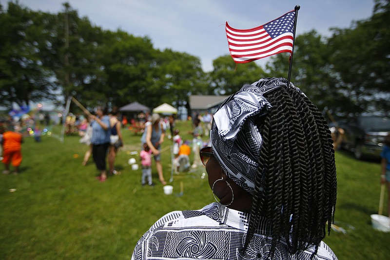 FILE - In this July 4, 2019, file photo, Malu Klo, an asylum seeker from the Congo, attends a picnic for refugees at Fort Williams Park in Cape Elizabeth, Maine. Three agencies in charge of resettling refugees in the U.S. are suing the Trump administration over the president's executive order allowing states and cities to block refugees from being settled in their areas. The lawsuit was filed Thursday, Nov. 21, 2019, by HIAS, Church World Service, and Lutheran Immigration and Refugee Services in U.S. District Court in Baltimore. (AP Photo/Robert F. Bukaty, File)