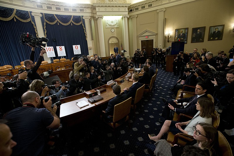 Former White House national security aide Fiona Hill, and David Holmes a U.S. diplomat in Ukraine, take their seats after they return from a break to testify before the House Intelligence Committee on Capitol Hill in Washington, Thursday, Nov. 21, 2019, during a public impeachment hearing of President Donald Trump's efforts to tie U.S. aid for Ukraine to investigations of his political opponents. (AP Photo/Jose Luis Magana)