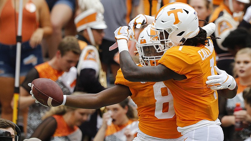 Staff photo by C.B. Schmelter / Tennessee running back Ty Chandler, with ball, celebrates with wide receiver Marquez Callaway after scoring a touchdown against UTC on Sept. 14 at Neyland Stadium.