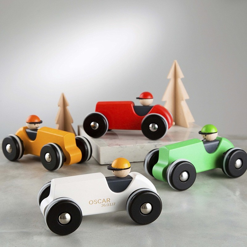 This image released by Etsy shows wooden racing car that can be engraved with a child’s name and a special date from Etsy seller  TwentySevenUK. The seller offers free shipping to the U.S. Each car is $43.05 and comes in white, yellow or green. (Stsy via AP)