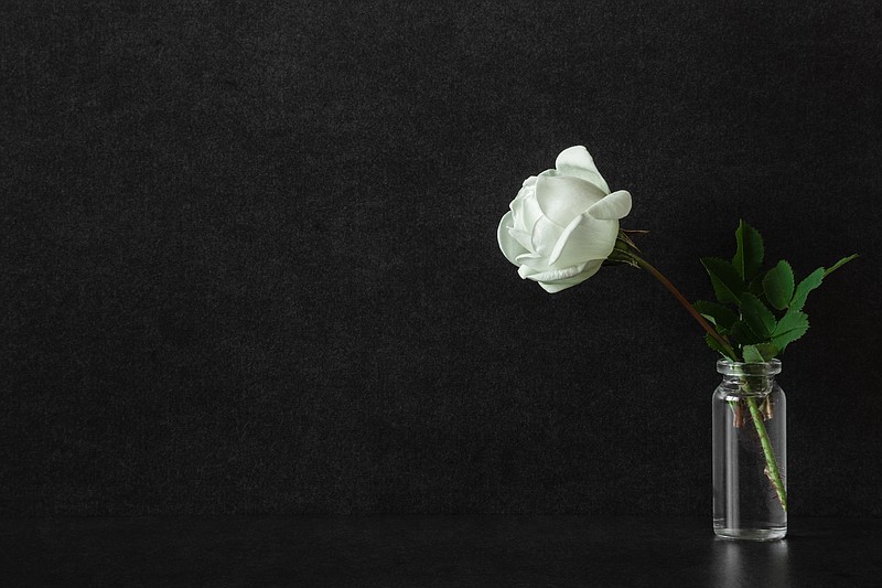White flower, condolences / Getty Images