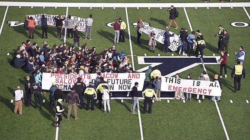 Fans stage a climate change protest at the Yale Bowl delaying the second half of the Yale/Harvard football game in New Haven, Connecticut, on November 23, 2019.