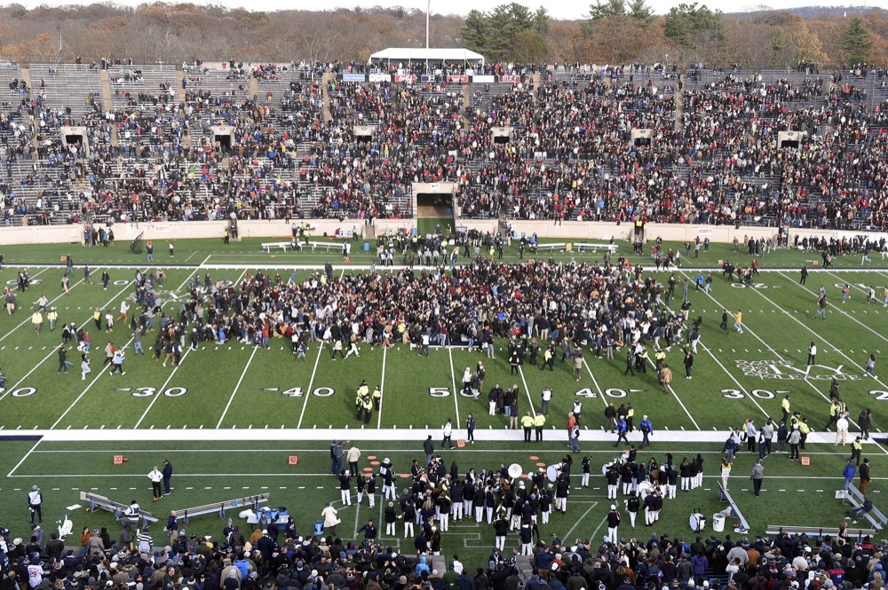 Fans stage a climate change protest at the Yale Bowl delaying the second half of the Yale/Harvard football game in New Haven, Connecticut, on November 23, 2019.
