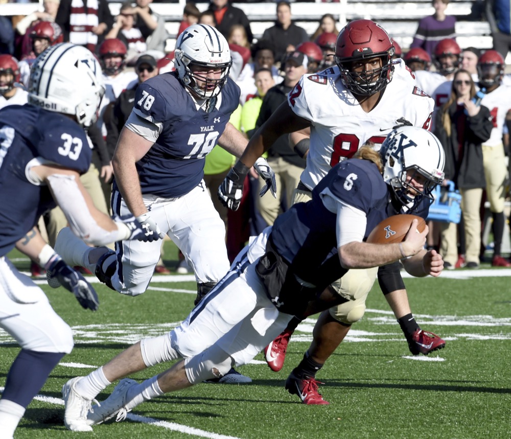 Yale quarterback Kurt Rawlings attempts to get a first down against Harvard in the first half of the Yale/Harvard football game in New Haven, Connecticut, on November 23, 2019.