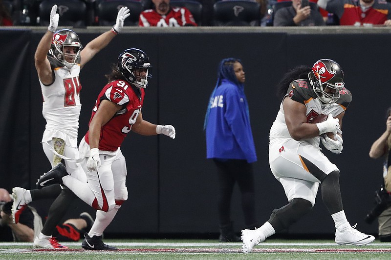 Tampa Bay Buccaneers defensive tackle Vita Vea (50) runs into the end zone for a touchdown against the Atlanta Falcons during the first half of an NFL football game, Sunday, Nov. 24, 2019, in Atlanta. (AP Photo/John Bazemore)