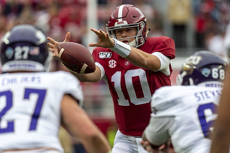 AP photo by Vasha Hunt / Alabama quarterback Mac Jones reaches for a wide snap from the shotgun formation during Saturday's home rout of Western Carolina.