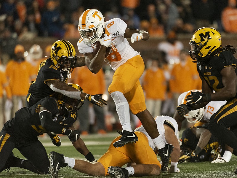 AP photo by L.G. Patterson / Tennessee running back Ty Chandler leaps between Missouri defenders Nick Bolton, right, Joshuah Bledsoe, top left, and Devin Nicholson, bottom left, during the second quarter of Saturday night's game in Columbia, Mo.