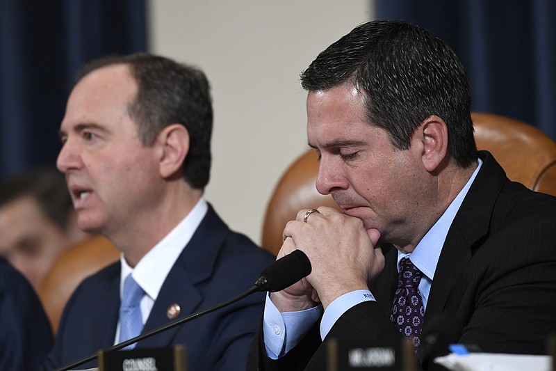 Susan Walsh, AP Photo/ Ranking member Rep. Devin Nunes, R-California, listens as House Intelligence Committee Chairman Adam Schiff, D-California, left, gives an opening statement before witnesses testify in a public impeachment hearing of President Donald Trump's efforts to tie U.S. aid for Ukraine to investigations of his political opponents.