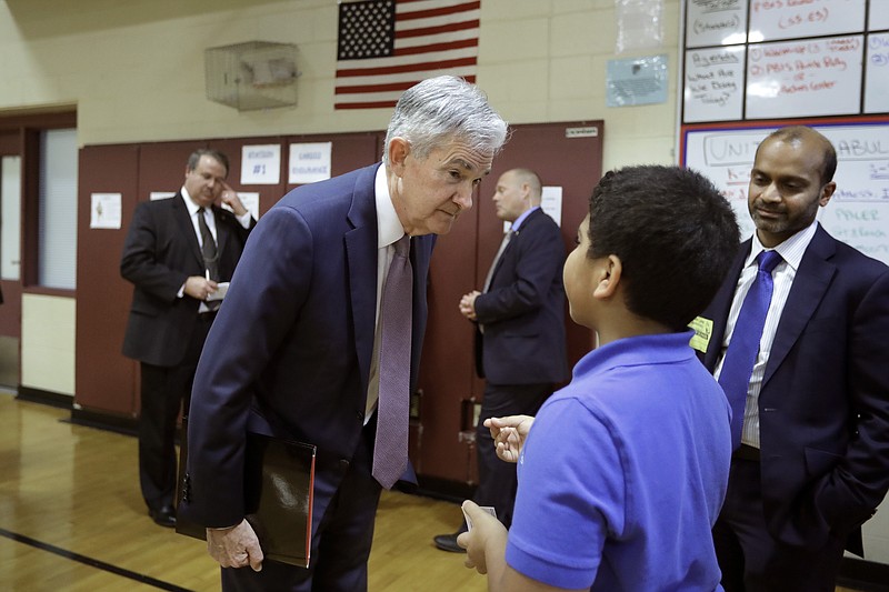 Federal Reserve Board Chair Jerome Powell, front left, speaks with fifth grader Brian Rosa, 11, of East Hartford, Conn., front right, during a visit to Silver Lane Elementary School, Monday, Nov. 25, 2019, in East Hartford. Rosa said he would like to be a banker when he grows up. (AP Photo/Steven Senne)