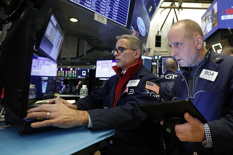 In this Nov. 20, 2019, file photo specialist Anthony Rinaldi, left, and trader Michael Urkonis work on the floor of the New York Stock Exchange. The U.S. stock market opens at 9:30 a.m. EST on Monday, Nov 25. (AP Photo/Richard Drew, File)
