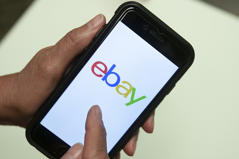 In this July 11, 2019, file photo, an Ebay app is shown on a mobile phone in Miami. EBay is selling StubHub to ticket seller viagogo for $4.5 billion. (AP Photo/Wilfredo Lee, File)