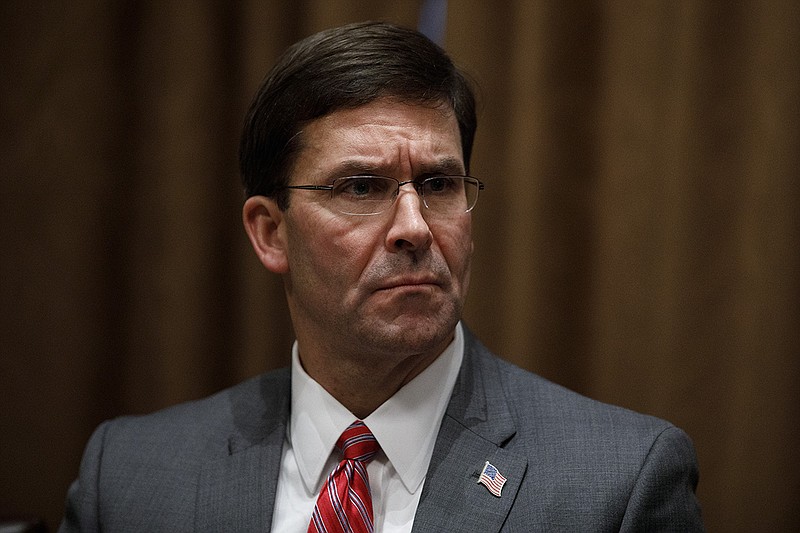 In this Oct. 7, 2019, file photo, Defense Secretary Mark Esper participates in a briefing with President Donald Trump and senior military leaders in the Cabinet Room at the White House in Washington. Esper declared on Monday, Nov. 25 that President Donald Trump ordered him to stop a disciplinary review of a Navy SEAL accused of battlefield misconduct, an intervention that raised questions about America's commitment to international standards for battlefield ethics. (AP Photo/Carolyn Kaster, File)