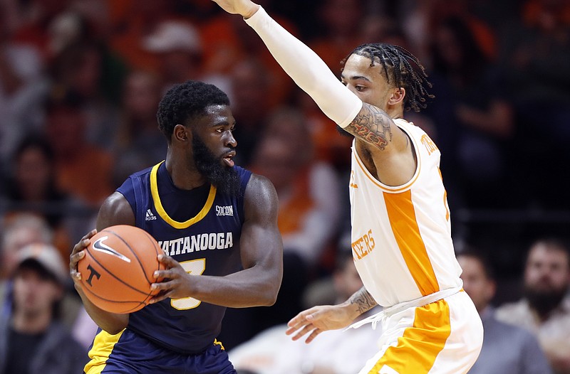 Chattanooga guard David Jean-Baptiste (3) looks to pass as he's defended by Tennessee guard Lamonte Turner, right, during the second half of an NCAA college basketball game Monday, Nov. 25, 2019, in Knoxville, Tenn. (AP Photo/Wade Payne)