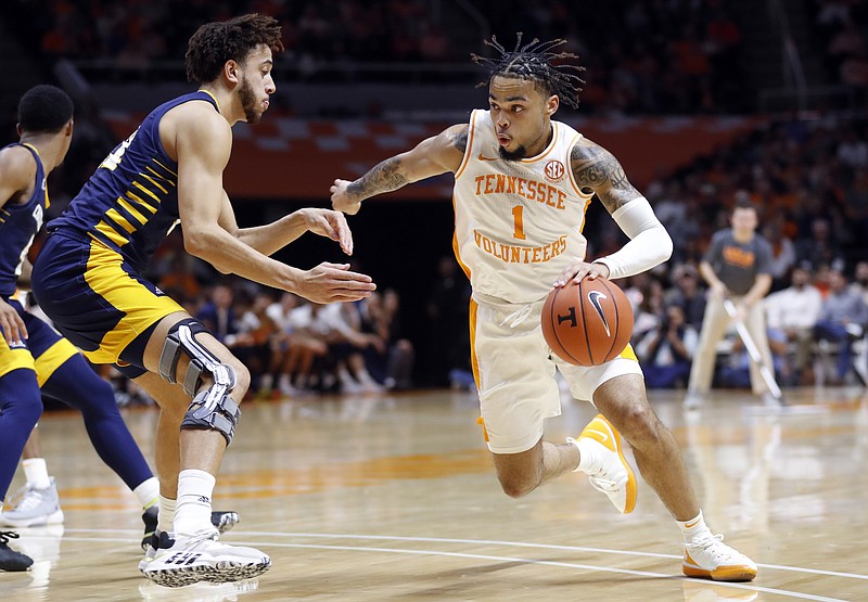 Tennessee guard Lamonte Turner, right, drives against Chattanooga forward Rod Johnson, left, during the second half of an NCAA college basketball game Monday, Nov. 25, 2019, in Knoxville, Tenn. (AP Photo/Wade Payne)