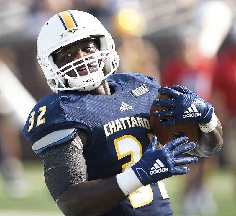 Staff Photo by Robin Rudd/ Ailym Ford (32) looks back after scoring a touchdown. The University of Tennessee at Chattanooga hosted the Western Carolina in a Southern Conference football game on September 28, 2019. Today was homecoming for UTC.