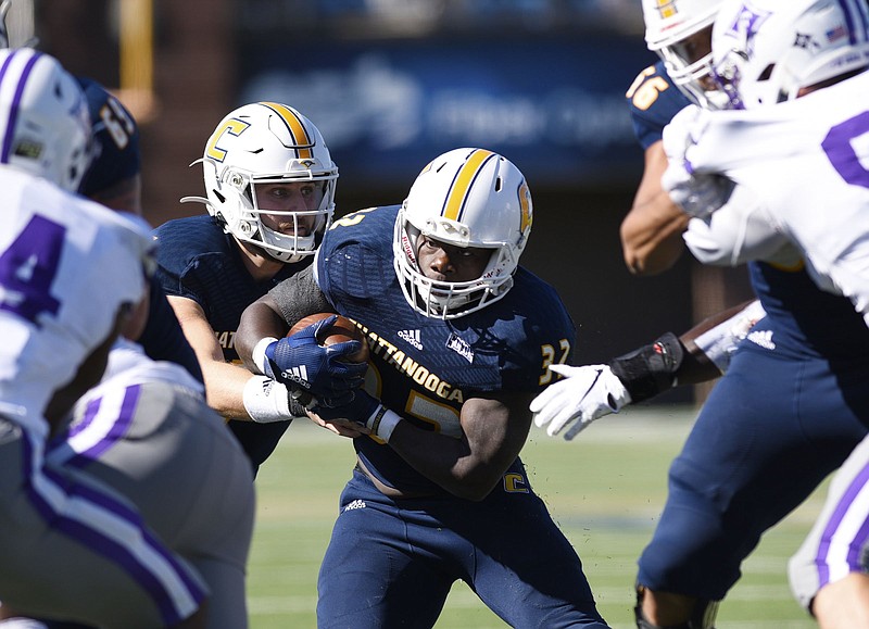 Staff Photo by Robin Rudd / UTC's Ailym Ford (32) looks for running room as he takes the handoff from Nick Tiano (7). The University of Tennessee at Chattanooga Mocs hosted the Furman Paladins in a Southern Conference football game at Finley Stadium on November 2, 2019.