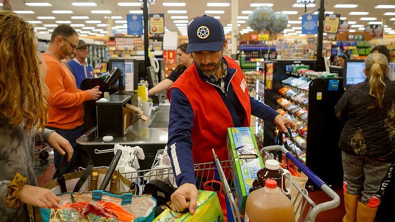 Staff photo by C.B. Schmelter / Chattanooga FC President Sheldon Grizzle helps bag groceries during the 13th annual Celebrity Bagging Event at the Food City in St. Elmo neighborhood on Tuesday, Nov. 26, 2019 in Chattanooga, Tenn. This year's annual fundraising event, held in conjunction with the United Way, helped to benefit the Times Free Press Neediest Cases appeal. Local celebrities volunteered their time to bag groceries and shoppers who wished to do so contributed to the United Way at checkout.