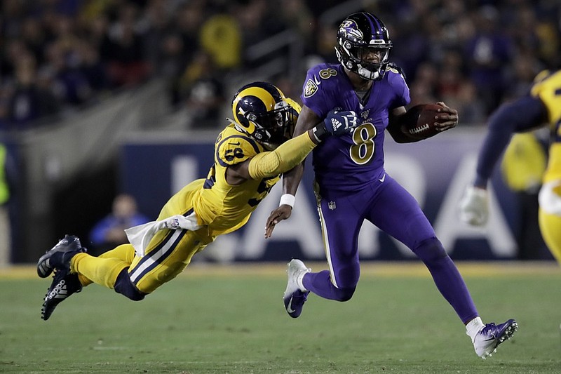 Baltimore Ravens quarterback Lamar Jackson is tackled by Los Angeles Rams defensive end Dante Fowler during the second half of a game on Nov. 25 in Los Angeles. / AP photo by Marcio Jose Sanchez