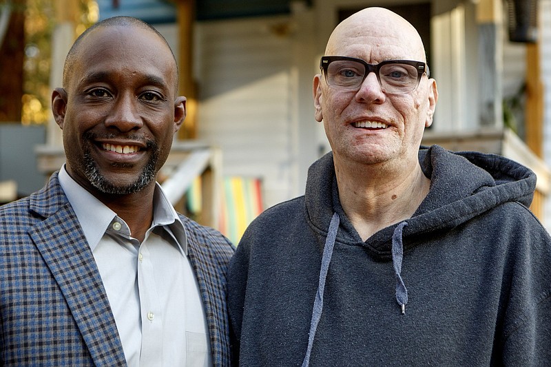 Staff photo by C.B. Schmelter / Jamaine Akins, left, and Bryant Ellis pose at Ellis's home on Wednesday, Nov. 13, 2019 in Hixson, Tenn. Ellis received help from Neediest Cases Fund in 2018 in order to rewire his entire house. Akins is a United Way volunteer and electrician who did the work for free.