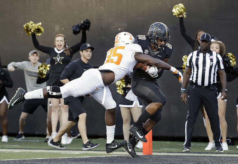 AP Photo/Mark Humphrey / Vanderbilt tight end Jared Pinkney scores a touchdown on a 17-yard pass as he is hit by Tennessee linebacker Daniel Bituli (35) in last year's Vandy win in Nashville.