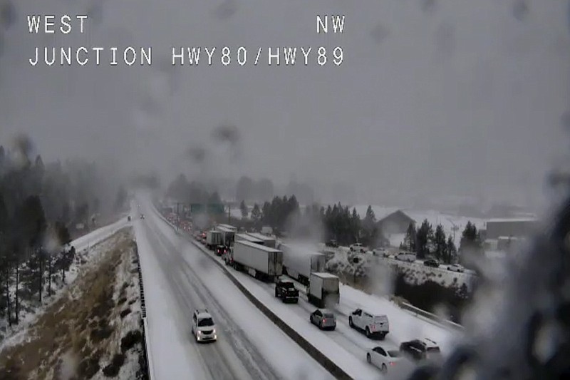 In this still image taken from a Caltrans remote video traffic camera, traffic is stopped along Interstate 80 because of multiple spinouts, Tuesday, Nov. 26, 2019, in Truckee, Calif. Northern California and southern Oregon residents are bracing for a "bomb cyclone" weather phenomenon that's expected at one of the busiest travel times of the year. The National Weather Service says the storm expected Tuesday into Wednesday could be like nothing experienced in the area for 20 years. (Caltrans via AP)