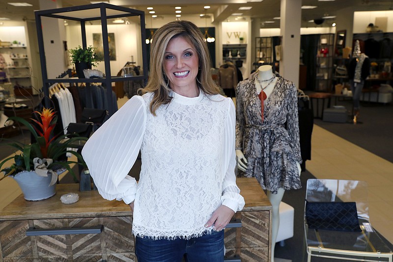 In this Tuesday, Nov. 26, 2019, photo Amy Witt, owner of the Velvet Window, posses for a photo at her retail store in Dallas. Heading into the holiday shopping season, Witt opened a physical store last week to attract more shoppers than just those who have been her online customers. (AP Photo/LM Otero)
