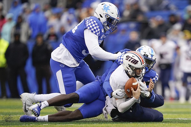 Kentucky linebacker Jordan Wright (15) and defensive tackle Abule Abadi-Fitzgerald (94) sack UT Martin quarterback John Bachus III (18) during the first half of an NCAA college football game, Saturday, Nov. 23, 2019, in Lexington, Ky. (AP Photo/Bryan Woolston)