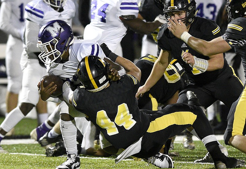 Staff Photo by Robin Rudd/ North Murray's Dylan Flood (44) stops the Hurricane quarterback for a loss. The North Murray Mountaineers hosted the Monroe Area Hurricanes the first round of the GHSA football playoffs on November 15, 2019.