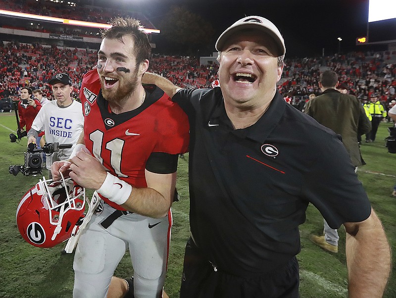 AP photo by Curtis Compton / Georgia football coach Kirby Smart and junior quarterback Jake Fromm celebrate after the Bulldogs beat visiting Texas A&M 19-13 last Saturday.