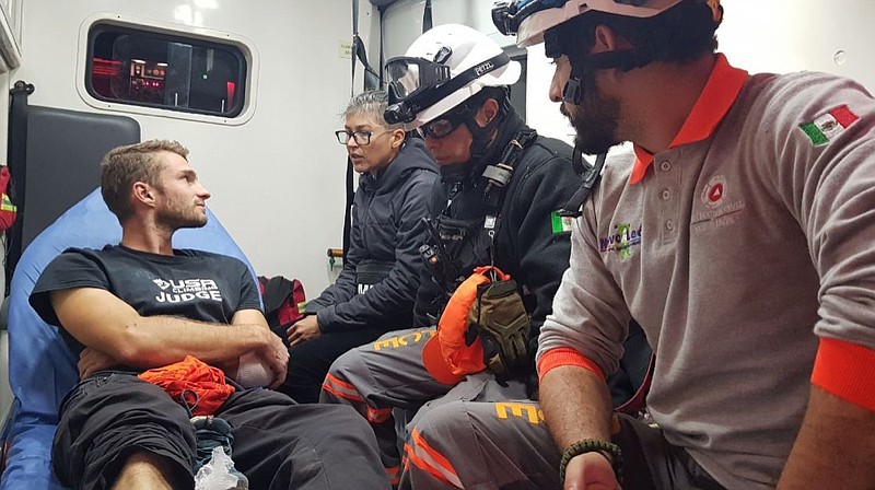 In this Wednesday, Nov. 27, 2019 handout photo released by Nuevo Leon State Civil Defense Agency, survivor Aidan Jacobson sits inside an ambulance after he was rescued after falling from the El Potrero Chico peak in Hidalgo, Mexico. Jacobson was climbing with California free solo climber Brad Gobright who died in the fall, civil defense officials in northern Mexico reported Thursday. (Nuevo Leon State Civil Defense Agency via AP)


