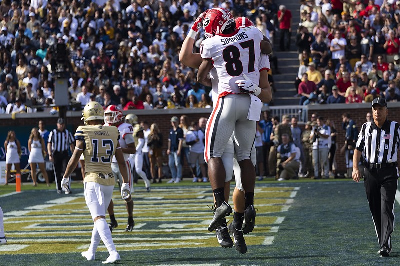 AP photo by John Amis / Georgia wide receiver Tyler Simmons (87) celebrates with tight end Charlie Woerner after Woerner caught a 20-yard touchdown pass from Jake Fromm in the first quarter of Saturday's game at Georgia Tech.