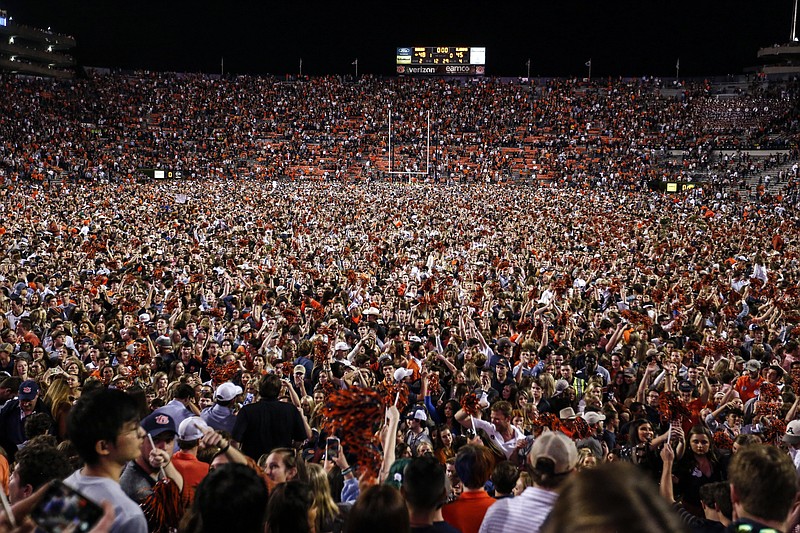 Auburn fans storm the field after they defeated Alabama 48-45 in an NCAA college football game Saturday, Nov. 30, 2019, in Auburn, Ala. (AP Photo/Butch Dill)

