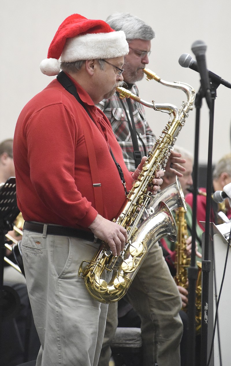 Staff File Photo / Mike LaRoche, foreground, of Sweet Georgia Sound big band plays at a previous Holiday Market. The big band is among local acts playing the Holiday Market this month.