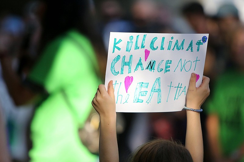 Staff file photo by Erin O. Smith / A child holds up a sign during the Climate Strike Friday, Sept. 20, 2019 in front of the Tennessee Aquarium in Chattanooga.