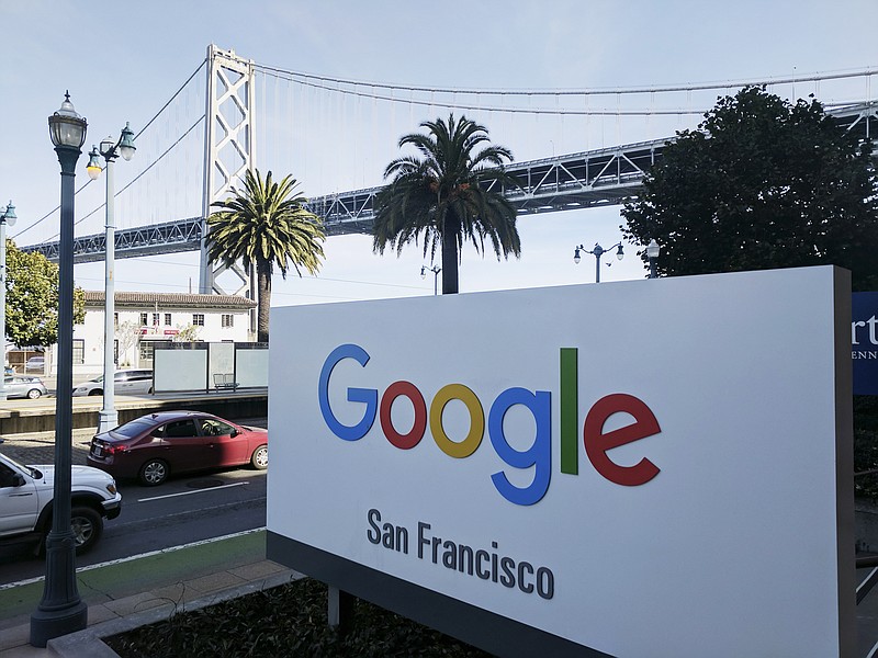 In this Oct. 31, 2018, file photo shows signage outside the offices of Google in San Francisco with the San Francisco-Oakland Bay Bridge in the background. Four workers fired from Google in November 2019 are planning to file charges against the company with a federal agency. They are claiming the company unfairly retaliated against them for organizing workers around social causes. (AP Photo/Michael Liedtke, File)