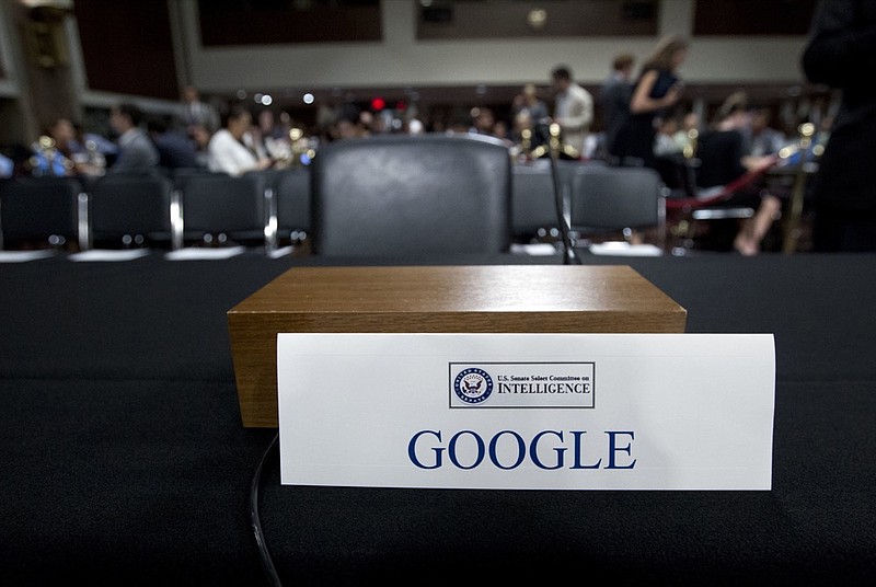 FILE- In this Sept. 5, 2018, file photo an empty chair reserved for Google's parent Alphabet, which refused to send its top executive, is seen before the Senate Intelligence Committee hearing on Capitol Hill in Washington. Momentum is gaining in Washington for a privacy law that would sharply reduce the ability of the largest technology companies to collect and distribute people’s personal data. Behind the drive for a law is rising concern over private data being compromised or distributed by Facebook, Google and other tech giants that have earned riches from marketing consumer information. (AP Photo/Jose Luis Magana, File)