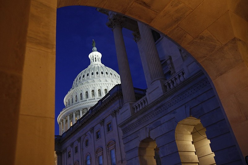 Light shines on the U.S. Capitol dome in Washington, early Wednesday, Dec. 4, 2019, prior to scheduled testimony from Constitutional law experts at a hearing before the House Judiciary Committee on the constitutional grounds for the impeachment of President Donald Trump. (AP Photo/Patrick Semansky)