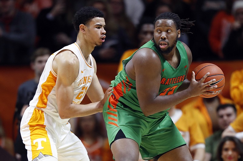 Florida A&M center Evins Desir, right, works for a shot while guarded by Tennessee forward Olivier Nkamhoua during the first half Wednesday night in Knoxville. / AP Photo by Wade Payne