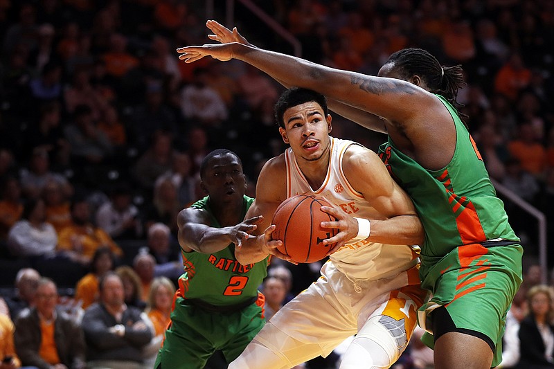 Tennessee forward Olivier Nkamhoua works for a shot Florida A&M center Evins Desi, right, and guard Kamron Reaves during the first half of Wednesday night's game in Knoxville. / AP photo by Wade Payne