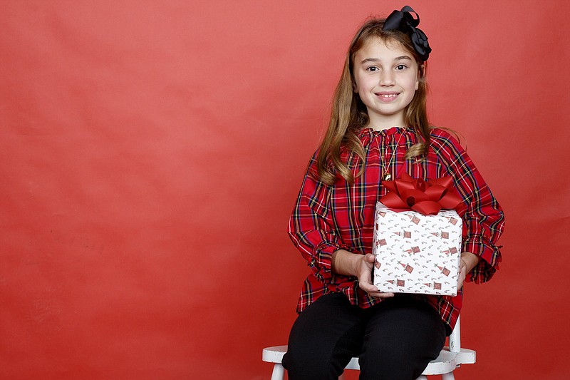 Staff photo by C.B. Schmelter / Lila Taslimi, the winner of the 2019 Lin C. Parker Wrapping Paper Design Contest, poses in the studio at the Times Free Press. Lila is a third-grader at Bright School.